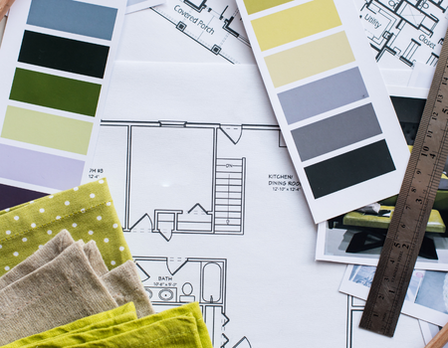 Color swatches, fabric samples, and architectural plans on a surface